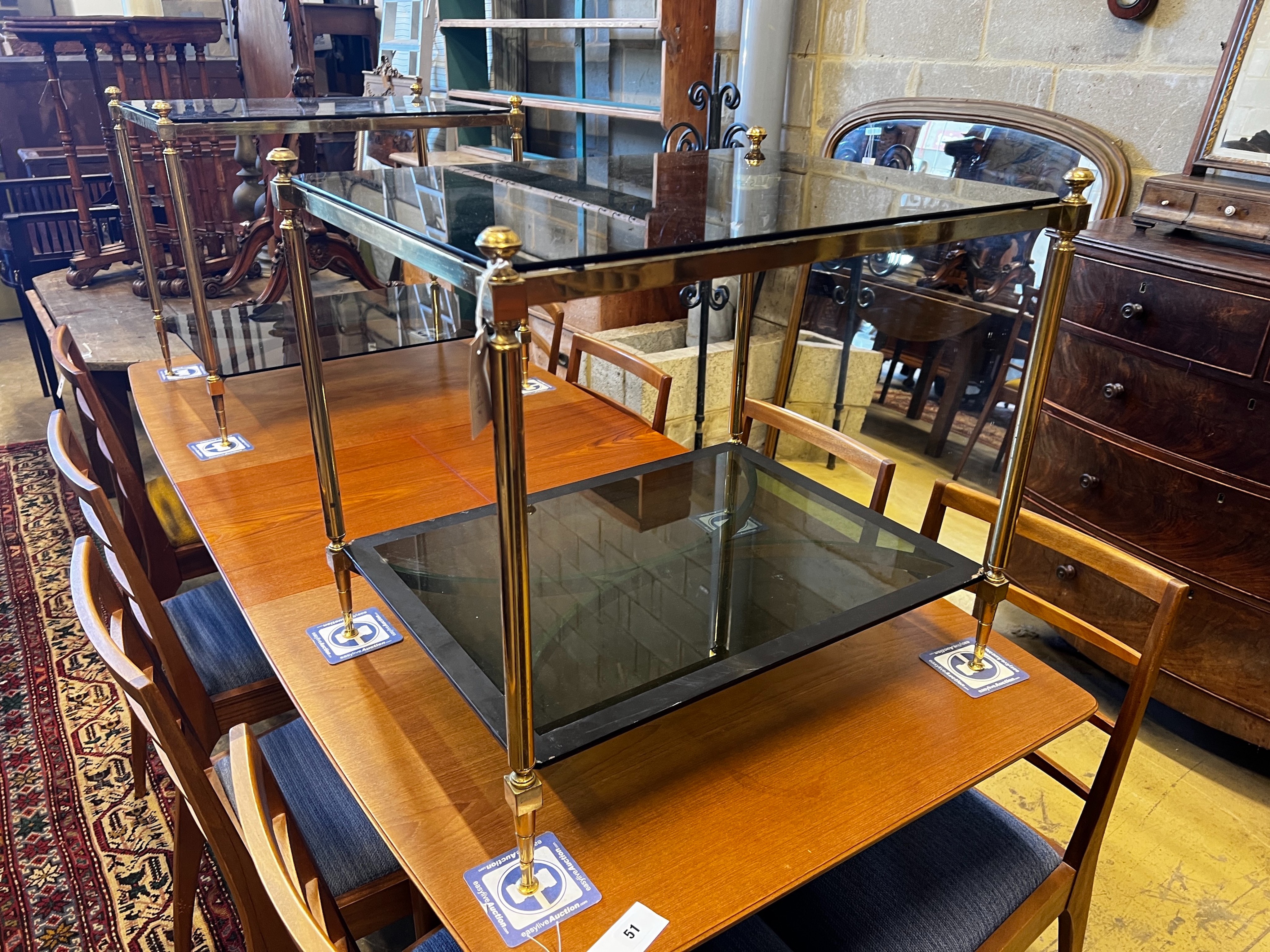 A pair of rectangular brass and black glass two tier tables, width 65cm, depth 50cm, height 59cm